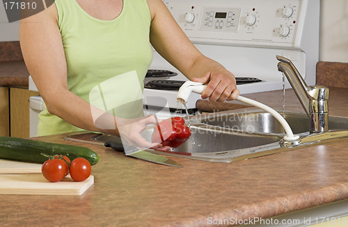 Image of woman using faucet