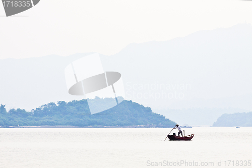 Image of Fisherman over the mountain and the sea alone