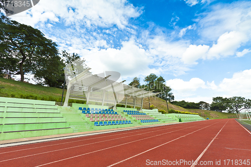 Image of Stadium chairs and running track in a sports ground