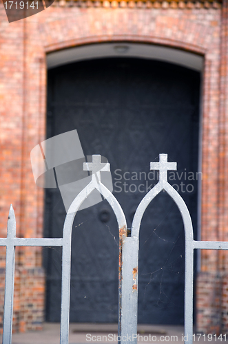 Image of church steel gate entrance closeup with cross 