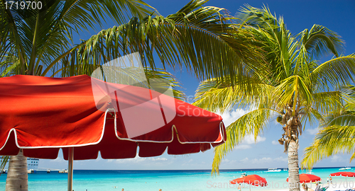 Image of Red Beach Umbrellas and turquoise Waters of Caribbean