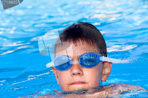 Image of The boy floats in pool