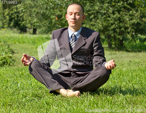 Image of Businessman Meditating Outdoors 