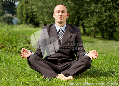 Image of Businessman Meditating Outdoors 