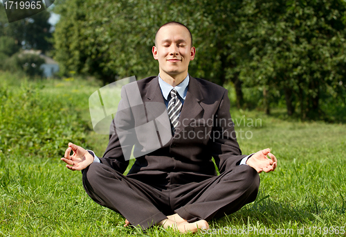 Image of Businessman Meditating Outdoors 