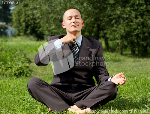 Image of Businessman Meditating Outdoors 