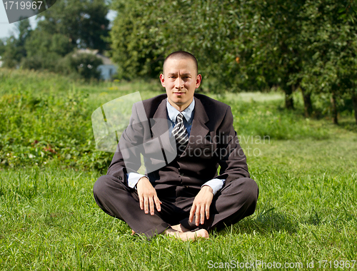 Image of Businessman Meditating Outdoors 