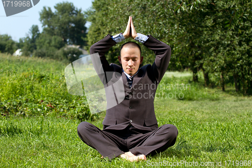 Image of Businessman Meditating Outdoors 