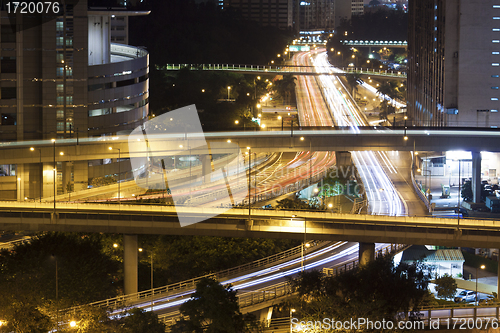 Image of Modern city with night traffic downtown