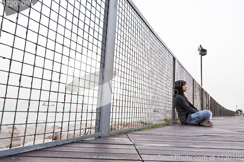 Image of Asian sad woman on floor