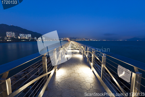 Image of Walkway bridge along the coast at night