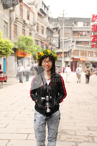 Image of Asian woman travelling in China with her camera