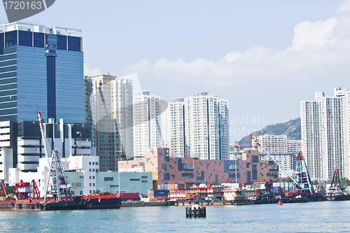 Image of Hong Kong apartment blocks and fishing boats at coast