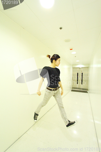 Image of Jumping woman in corridor