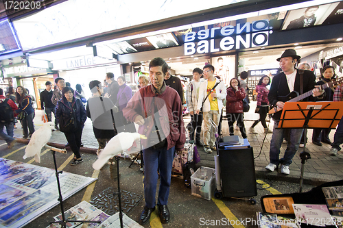 Image of Performers along the street in Hong Kong at night