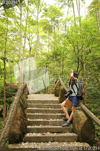 Image of Asian woman travelling in forest