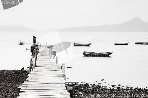 Image of Lonely pier along the coast, low saturation image.