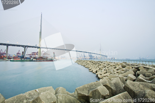Image of Bridge with cargo ships in Hong Kong at day
