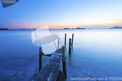 Image of Sunset along a wooden pier 