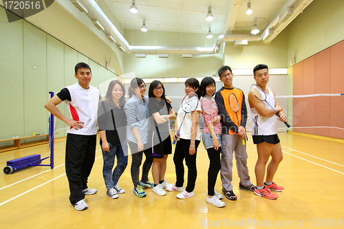 Image of Asian friends playing badminton