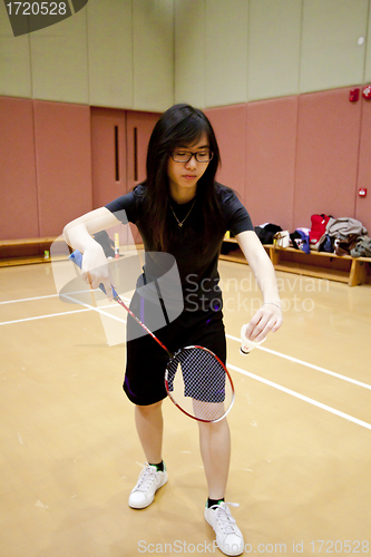 Image of Asian woman playing badminton