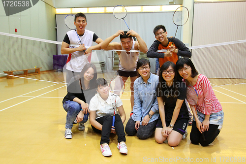 Image of Asian friends playing badminton