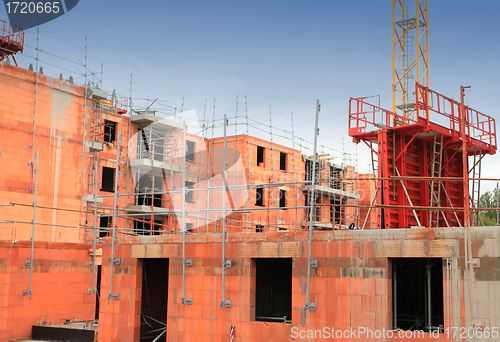 Image of residential building under construction in red brick