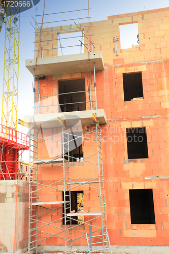 Image of residential building under construction in red brick