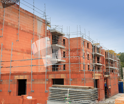 Image of residential building under construction in red brick