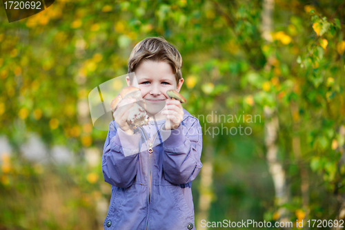 Image of Happy kid with wild mushrooms