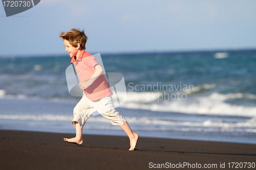 Image of Boy running at black sand beach