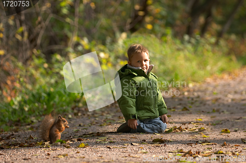 Image of Little boy and squirrel