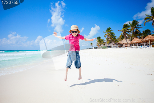 Image of Happy boy jumping on beach