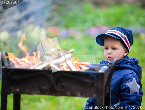 Image of Boy looking to fire