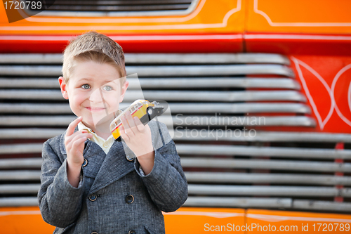 Image of Boy outdoors with toy