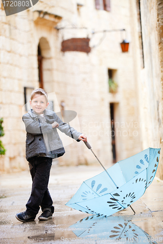 Image of Cute boy on rainy day