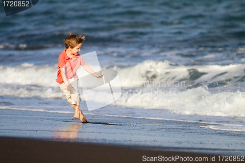 Image of Kid runs on the beach