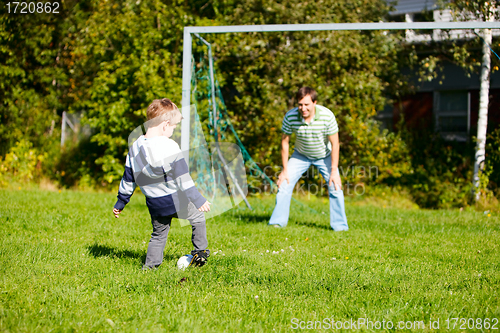 Image of Family playing football