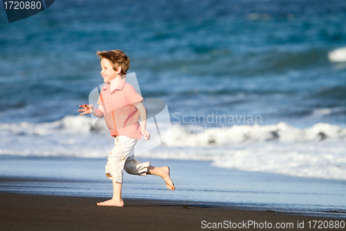 Image of Kid runs on the beach