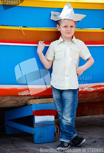 Image of Boy near colorful boat