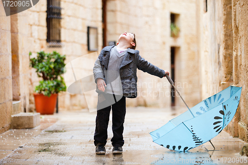 Image of Cute boy on rainy day