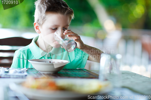 Image of Little boy drinking water