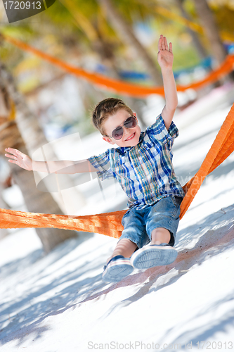 Image of Happy boy sitting in hammock