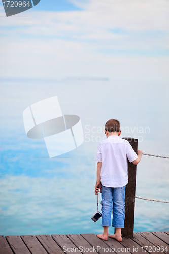 Image of Little boy looking at ocean