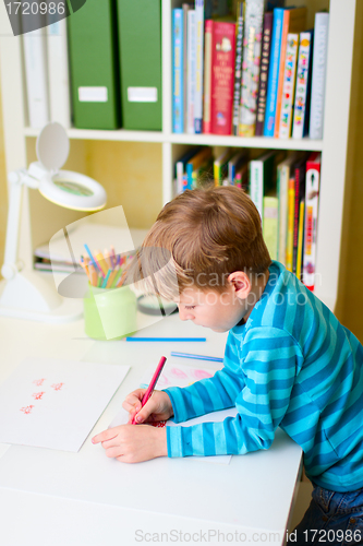 Image of Little boy studying at home