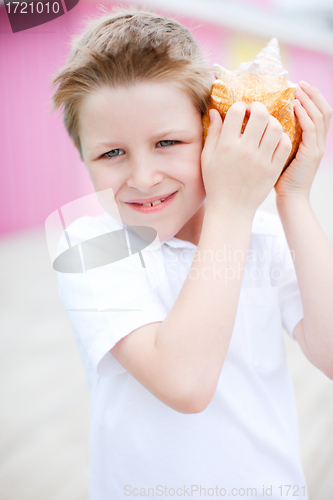 Image of Cute boy with seashell