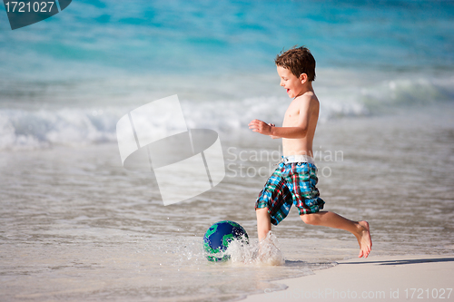 Image of Boy playing with ball on beach