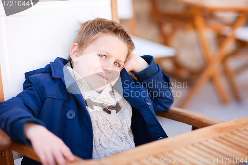 Image of Cute boy at outdoor cafe