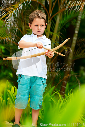 Image of Cute boy playing with bow and arrows