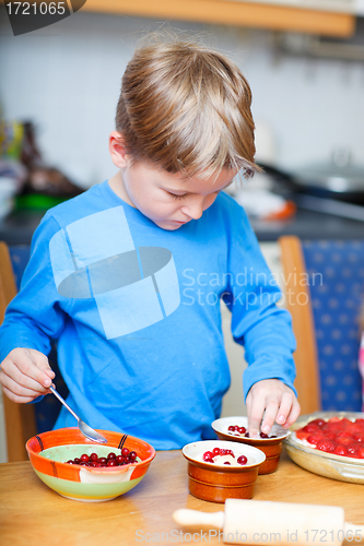 Image of Cute boy making cupcakes